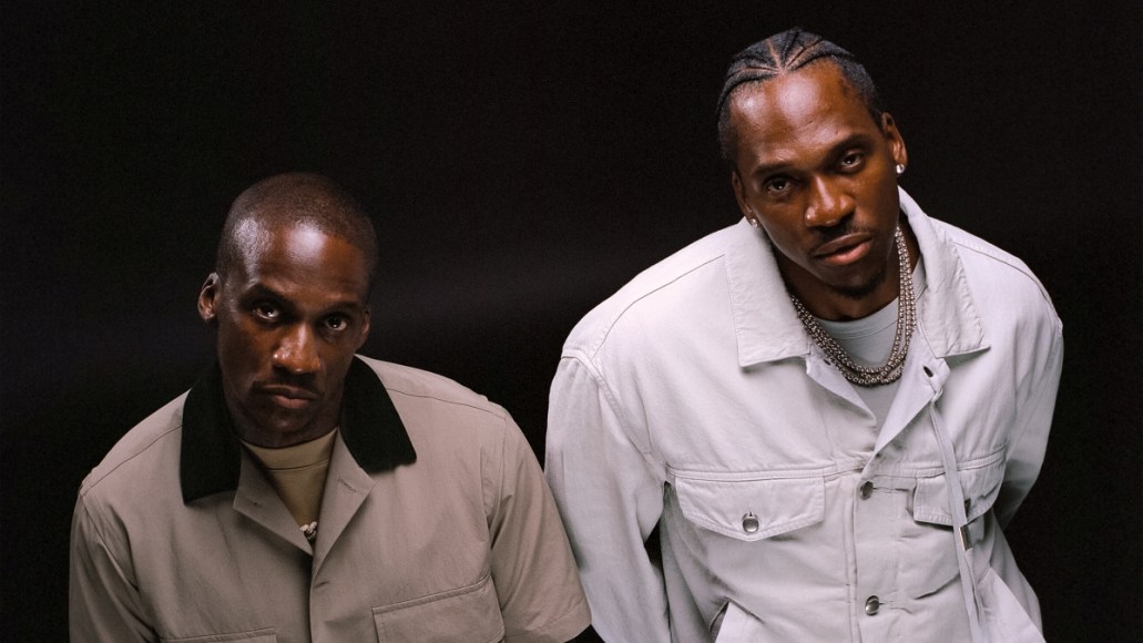Hip hop duo Clipse stares up at the camera against a black background